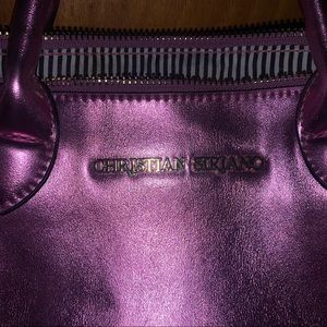 A beautiful pink purse with zebra interior